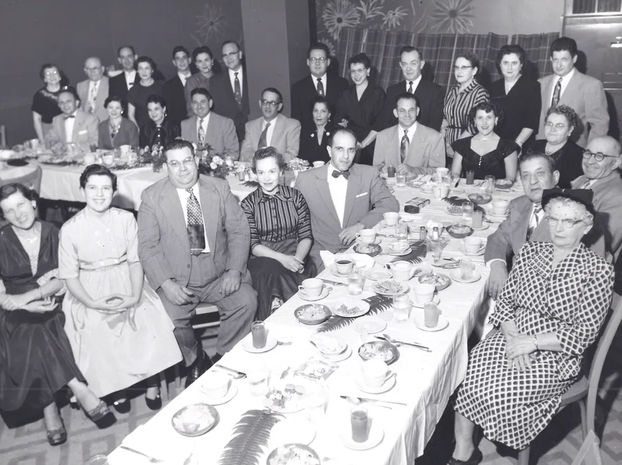The CBS Family Club gathered at a long table